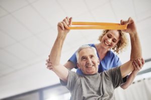 Senior resident and therapist in physical therapy session